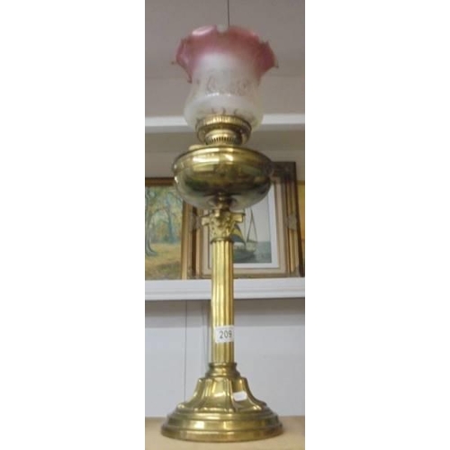 209 - A brass Corinthian column oil lamp with later etched glass shade. COLLECT ONLY.