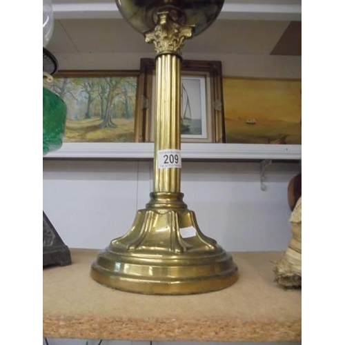 209 - A brass Corinthian column oil lamp with later etched glass shade. COLLECT ONLY.