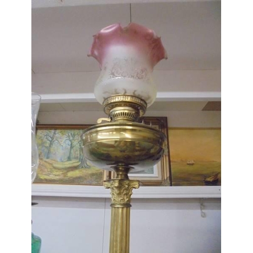 209 - A brass Corinthian column oil lamp with later etched glass shade. COLLECT ONLY.