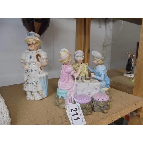 211 - A 19th century nodding head teaparty group and a 19th century nodding Granny figure.