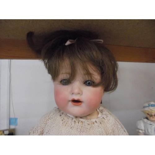 212 - A 19th century porcelain headed doll marked Armand Marseille, Germany, 9900, A-4-M.