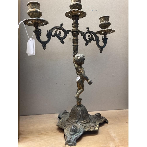 416 - A Brass candelabra featuring a cherub