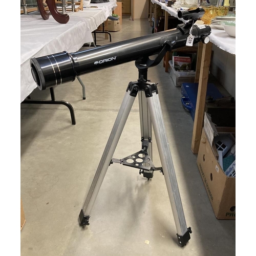 482 - An Orion Observer II telescope on tripod stand