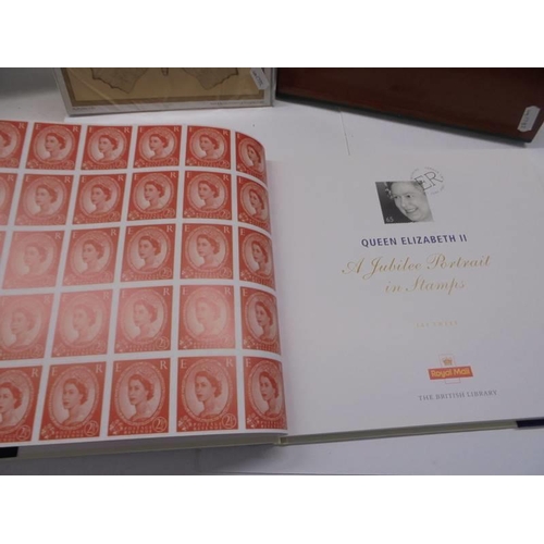 109 - A Queen Elizabeth II portrait in stamps book, a 1987 Royal Mail stamp book and a set of butterfly st... 