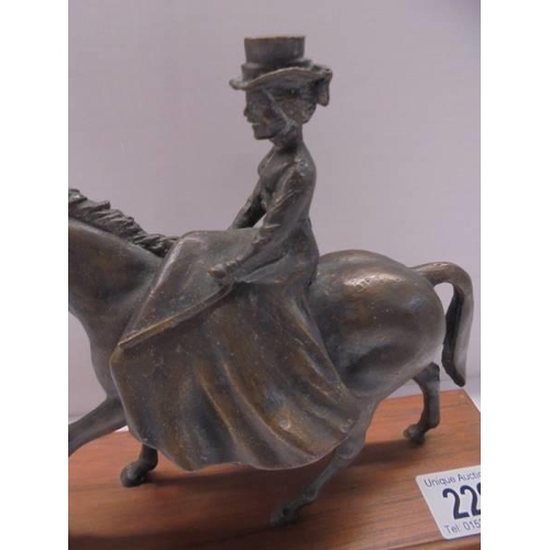 229 - A bronze figure of a lady riding a horse side saddle, length 18cm, height 15.5 cm.