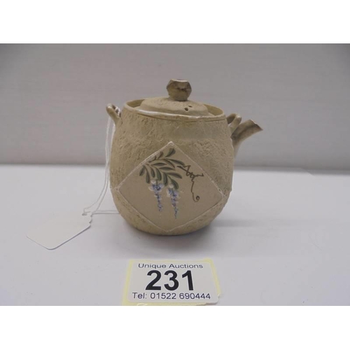 231 - A miniature Chinese hand painted porcelain tea pot.