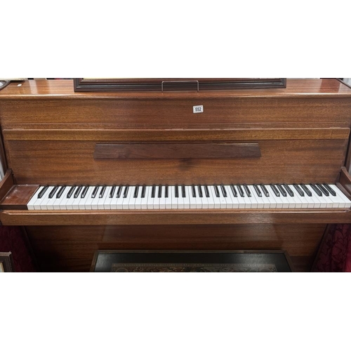 552 - A mahogany upright piano in working condition. COLLECT ONLY