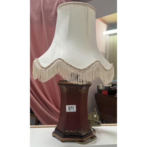 571 - A wood effect lamp base with fringed shade