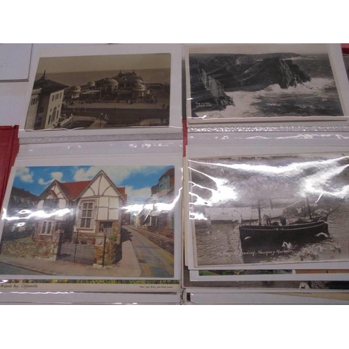 113 - Two albums of approximately 350 mainly topographical postcards.