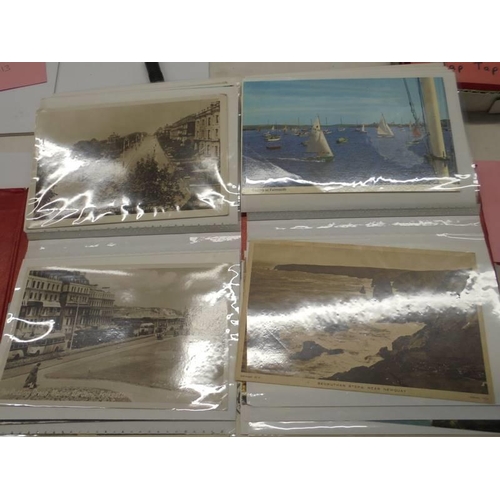 113 - Two albums of approximately 350 mainly topographical postcards.