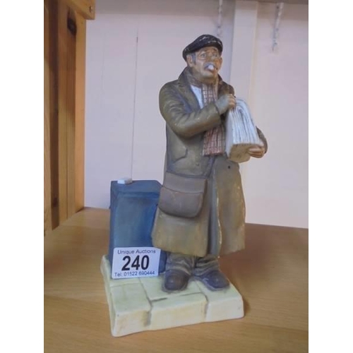 240 - A porcelain figure of a Newspaper seller.