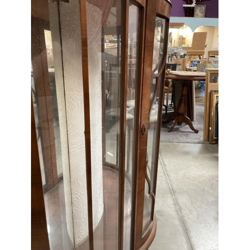 577 - A bow fronted Astral glazed China cabinet with two shaped glass shelves on Queen Anne style legs 120... 