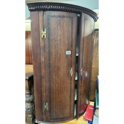 585 - A bow fronted inlaid mahogany hanging corner cupboard with 3 interior shelves lock with key brass es... 