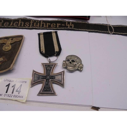 114 - German badges and bands including Iron Cross 2nd class, SS armband, SS skull pin etc.,