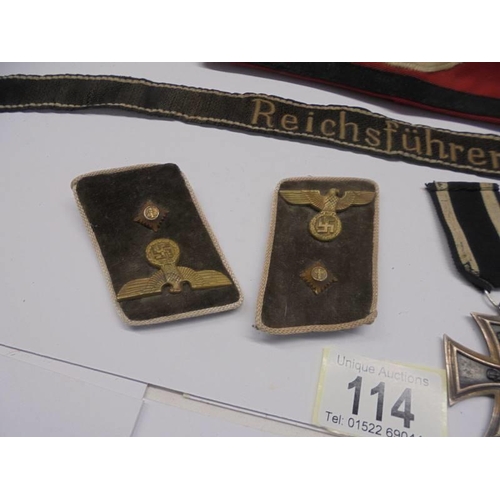 114 - German badges and bands including Iron Cross 2nd class, SS armband, SS skull pin etc.,