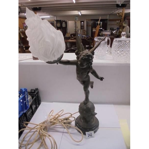 242 - A table lamp on marble base featuring a cherub on a globe complete with flame shade, COLLECT ONLY.