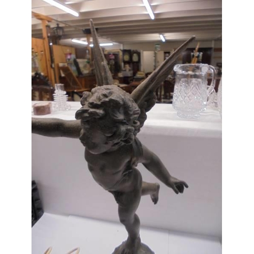 242 - A table lamp on marble base featuring a cherub on a globe complete with flame shade, COLLECT ONLY.