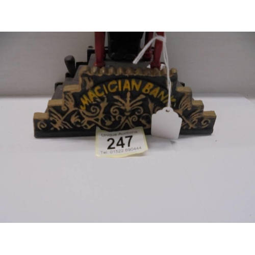 247 - A cast iron magician money bank.