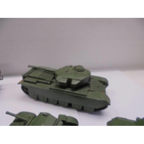 257 - Seven Dinky military vehicles including tanks, cannon etc.,