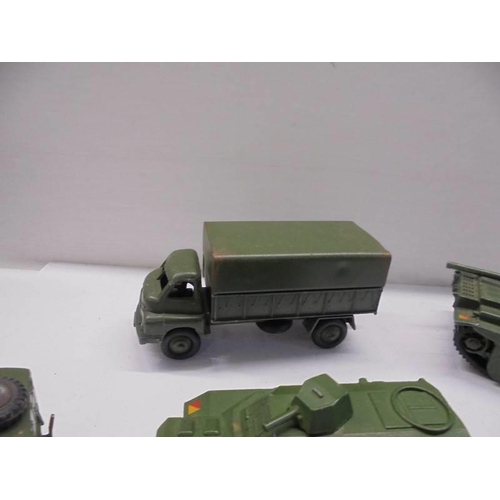 257 - Seven Dinky military vehicles including tanks, cannon etc.,