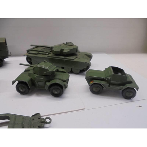 257 - Seven Dinky military vehicles including tanks, cannon etc.,