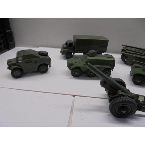 257 - Seven Dinky military vehicles including tanks, cannon etc.,