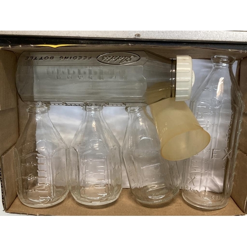 638 - A quantity of vintage baby bottles etc