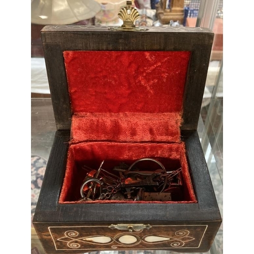 656 - A Hardwood jewellery casket with mother of pearl & white metal inlay & contents including cufflinks ... 