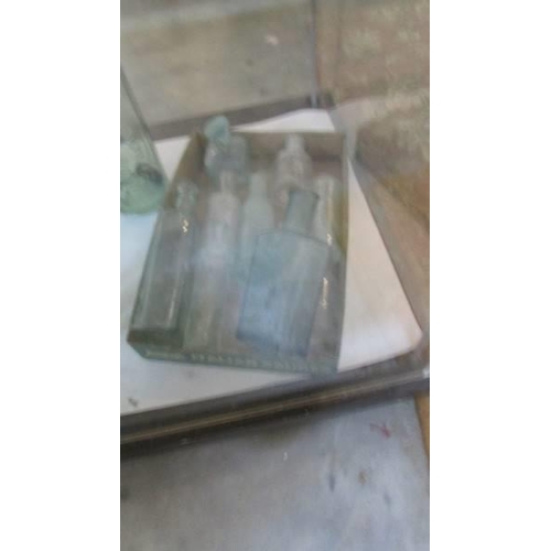 261 - A quantity of old glass bottles, some a/f.