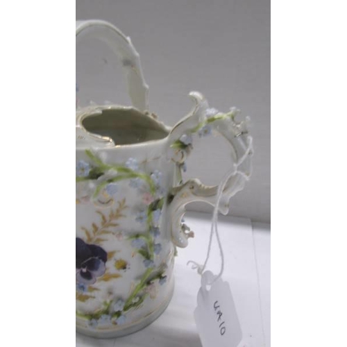 262 - A superb antique porcelain watering can encrusted with flowers.