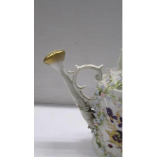 262 - A superb antique porcelain watering can encrusted with flowers.