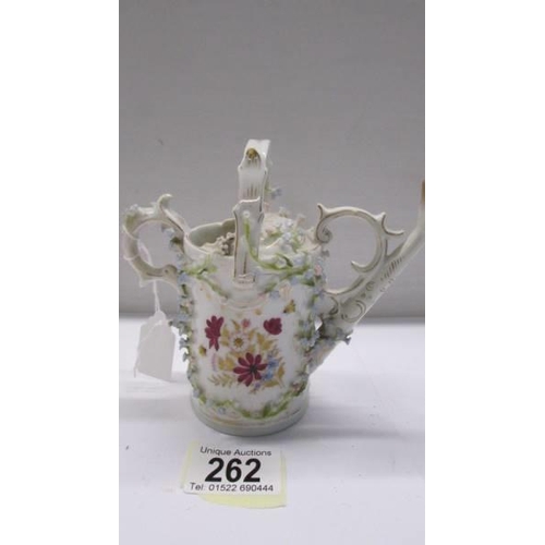 262 - A superb antique porcelain watering can encrusted with flowers.