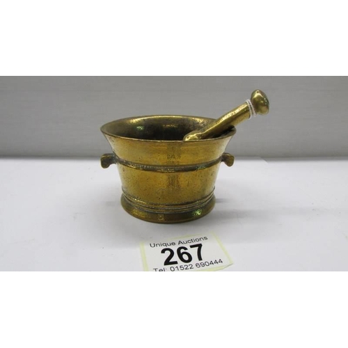 267 - A small brass pestle and mortar.