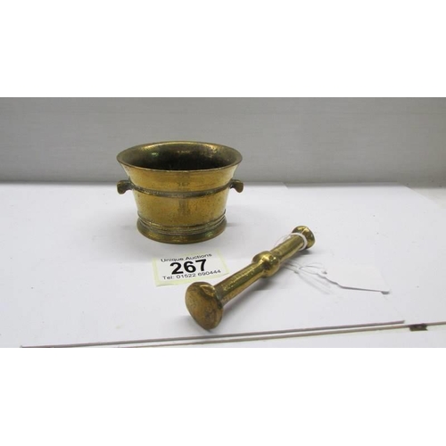 267 - A small brass pestle and mortar.