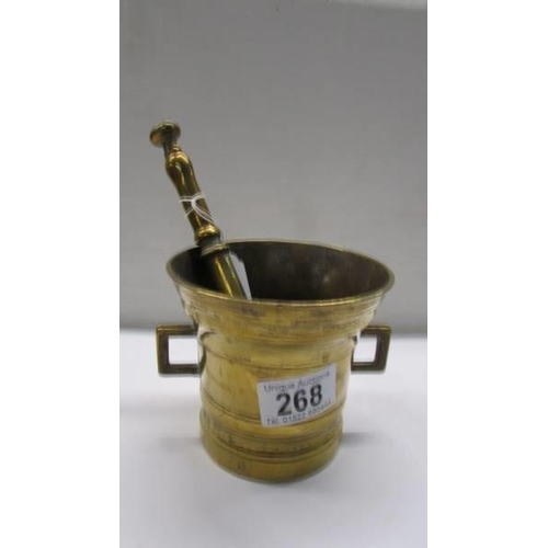 268 - A brass pestle and mortar stamped 1825.