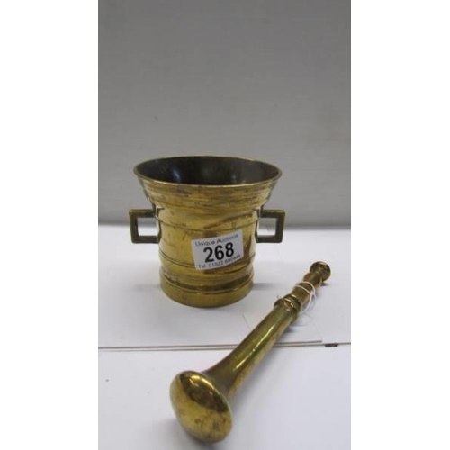 268 - A brass pestle and mortar stamped 1825.