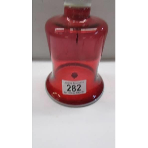 282 - A cranberry glass bell.