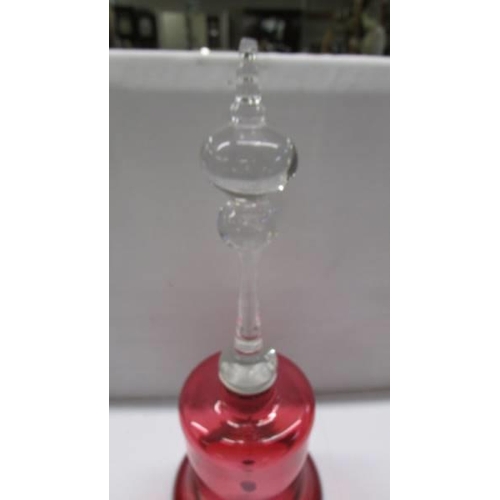 282 - A cranberry glass bell.