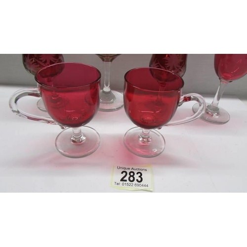 283 - Six items of cranberry glass.