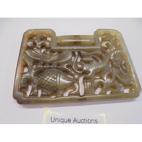 32 - A Chinese jade lock shaped carved pendant depicting fish, 92 x 67 x 6 mm.