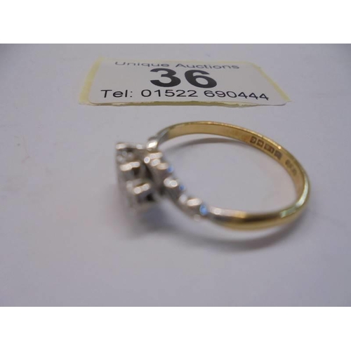 36 - A vintage diamond three stone ring hallmarked for Birmingham in an 18ct gold twist design shank, siz... 