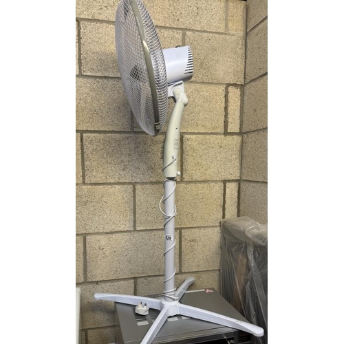 829 - An electric fan on a tall stand