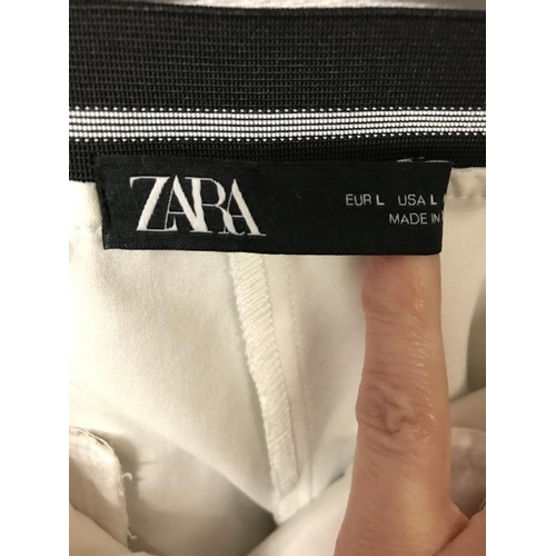 2141 - A collection of four pairs of trousers and one skirt. Including Zara