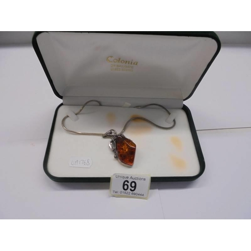 69 - A silver and amber pendant on a 41 cm chain in original box.