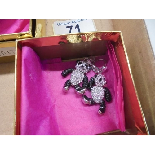 71 - A Butler & Wilson jointed crystal panda set comprising ring, earrings and pendant.