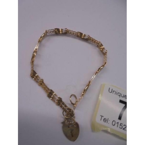 73 - A 9ct gold bracelet with heart padlock. 2.53 grams.