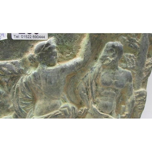 289 - A heavy cast metal plaque depicting a classical scene.