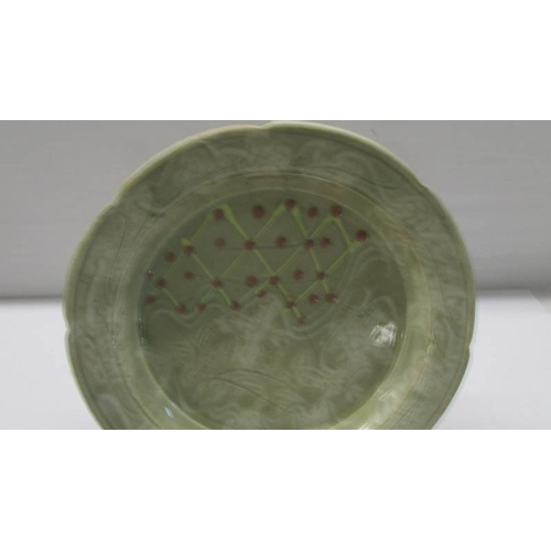 291 - An unusual art pottery plate - possibly Chinese.