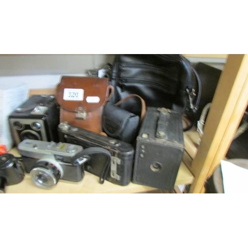 320 - A collection of vintage camera's including Brownie and folding examples etc.,