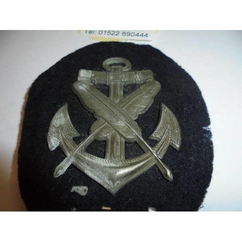 79 - An old cloth naval badge with metal back.